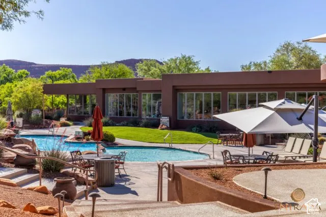 Two distinct swimming pools with integrated steps, surrounded by expansive concrete decking
