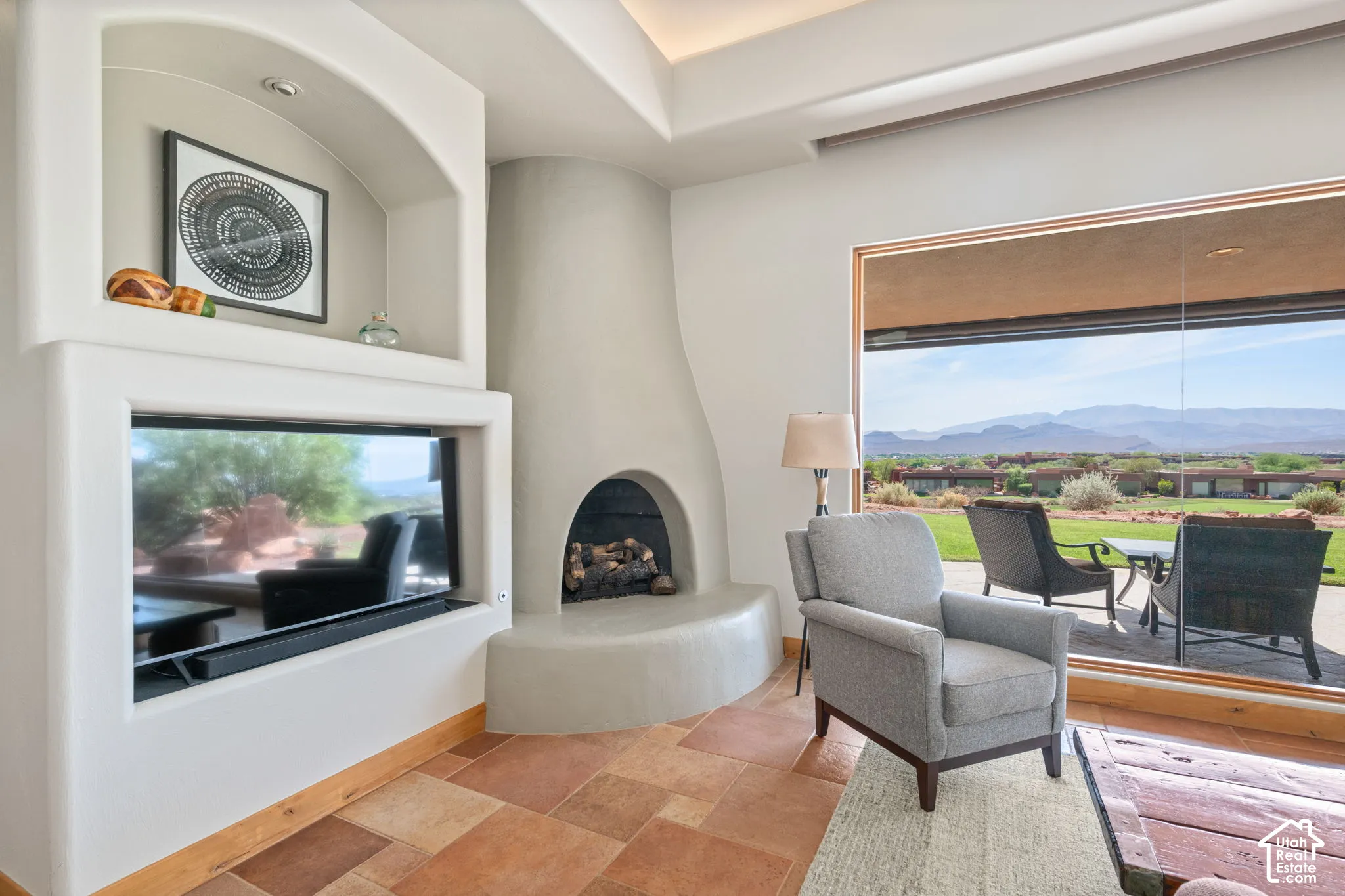 Recessed fireplace with built-in media niche, large picture window, and multi-toned tile flooring
