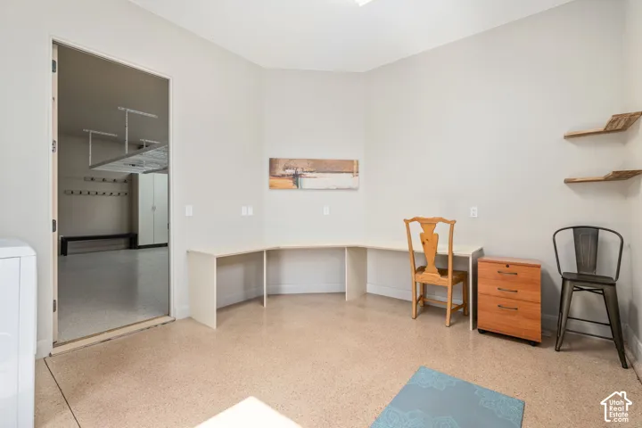 Built-in L-shaped desk, two wall-mounted shelves, and a durable epoxy-coated floor
