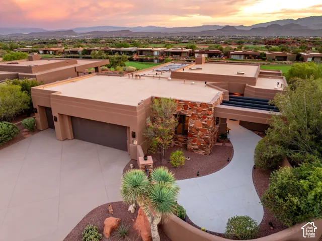 Contemporary desert architecture featuring a stucco exterior, stone accent walls, and a flat roofline