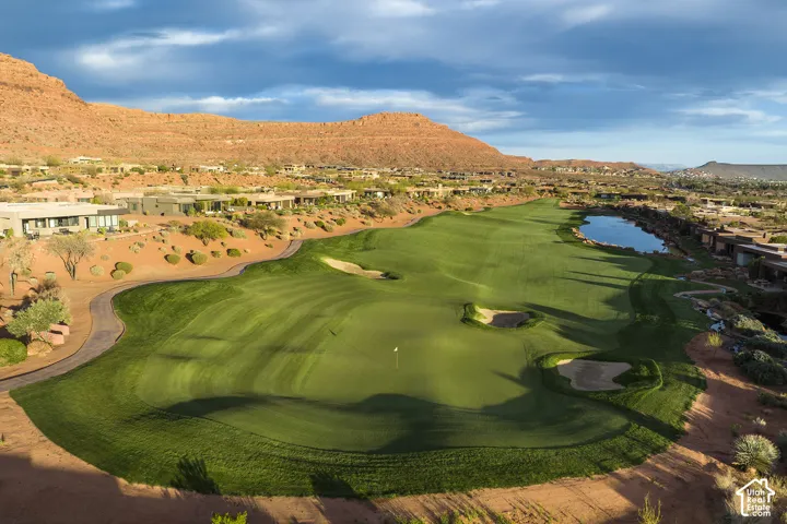 Expansive golf course with manicured greens, sand traps, and a water feature
