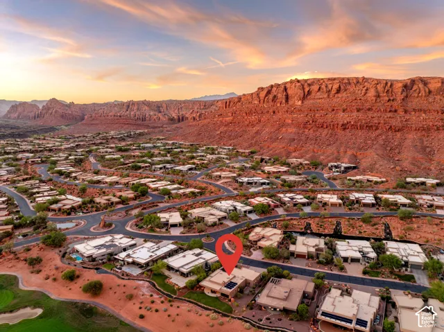 Residential property set against a dramatic rock formation backdrop