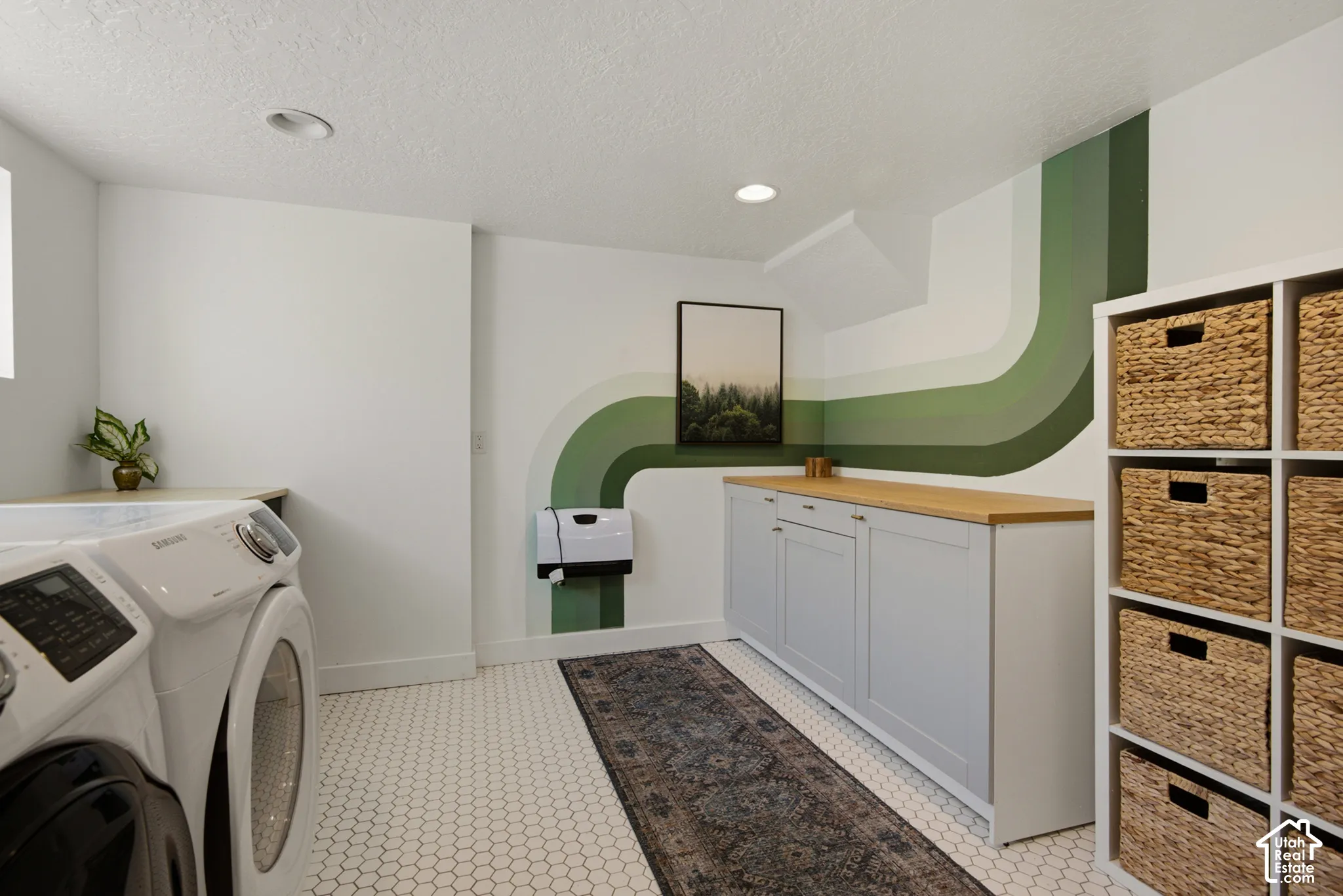 White hexagonal tile flooring, built-in storage shelving, wood-finish countertop, recessed ceiling lighting, and built-in cabinetry