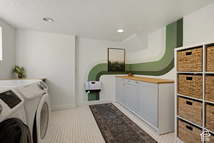 White hexagonal tile flooring, built-in storage shelving, wood-finish countertop, recessed ceiling lighting, and built-in cabinetry