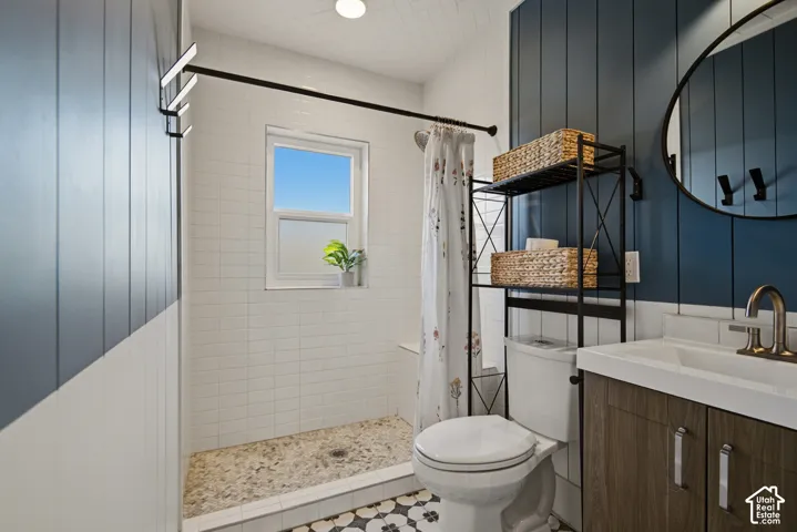 Walk-in shower with pebble tile flooring and white subway tile surround