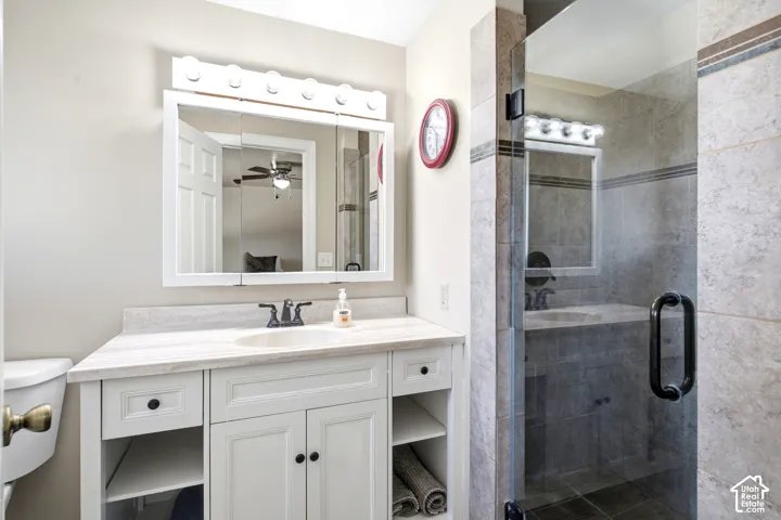 Primary bath with beautifully appointed tiled shower.