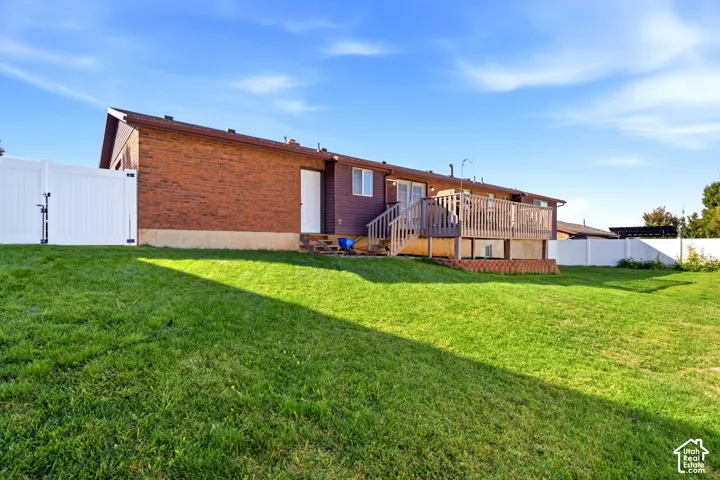 BACK OF HOME and you can see access to the garage and deck with access to the main level.