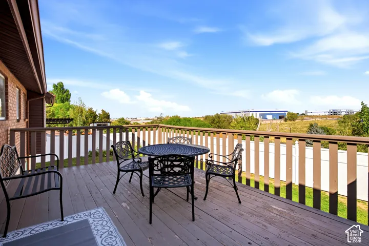 LARGE DECK overlooking the large fully fenced back yard with mountain views