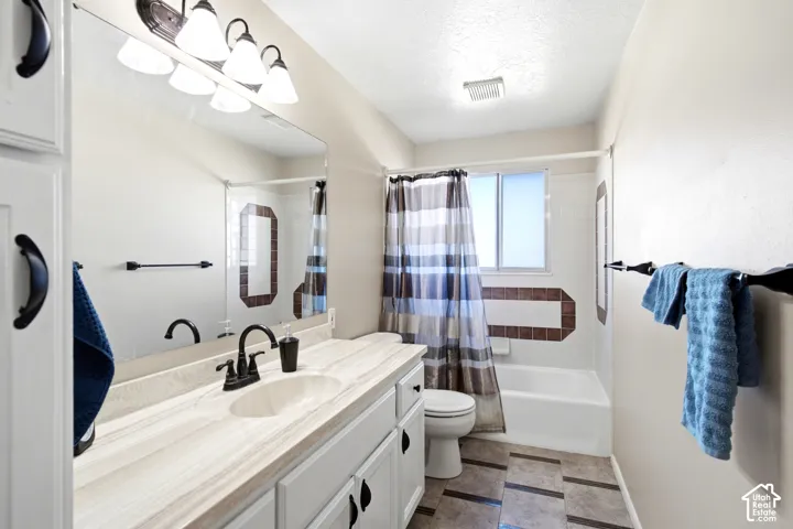 MAIN FULL BATHROOM with beautifully tiled floors.