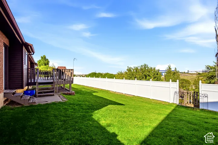 BACKYARD that is fully fenced in with a new landing and staircase to the yard below with all the fruit trees and garden areas.