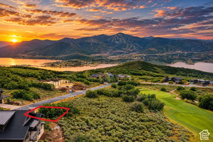 Elevated property featuring natural landscaping, paved road frontage, and a golf course border