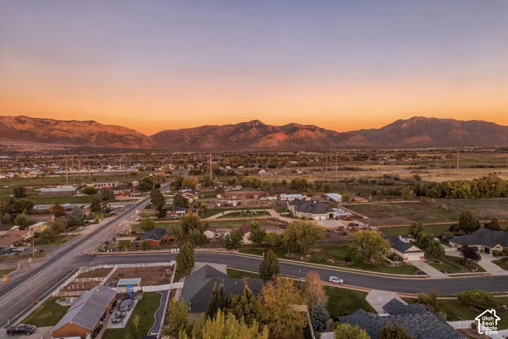 Aerial perspective featuring expansive mountain range backdrop and mature trees