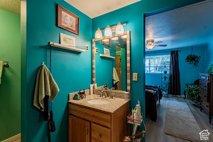 Single vanity with a light-toned countertop and an integrated sink