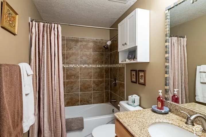 Tub and shower combination featuring tiled surround with mosaic accent