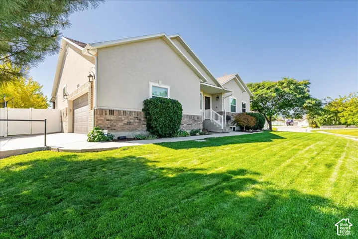 Expansive manicured lawn with defined striping and mature landscaping