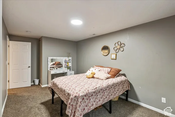 Neutral-toned interior space featuring wall-to-wall carpeting and a recessed ceiling light fixture