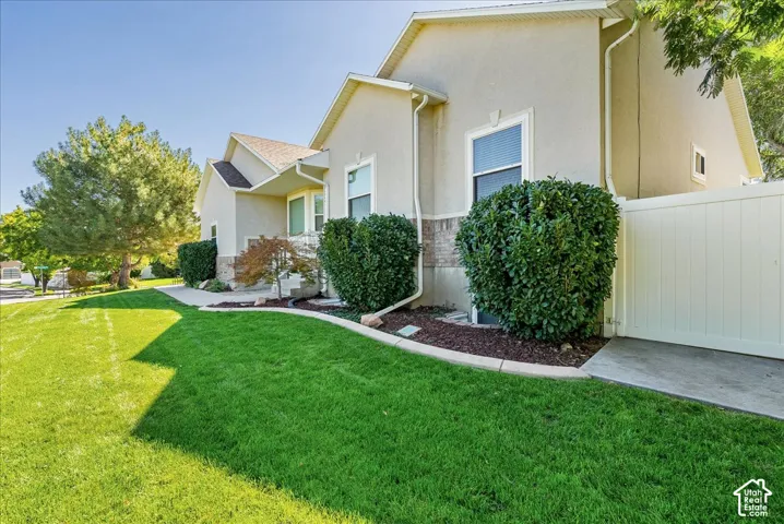 Expansive manicured lawn with mature landscaping and lush green space