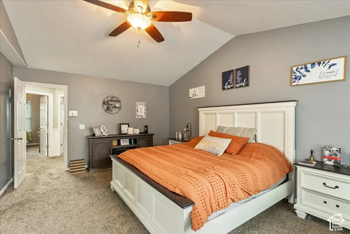 Vaulted ceilings featuring a centrally mounted ceiling fan with integrated lighting