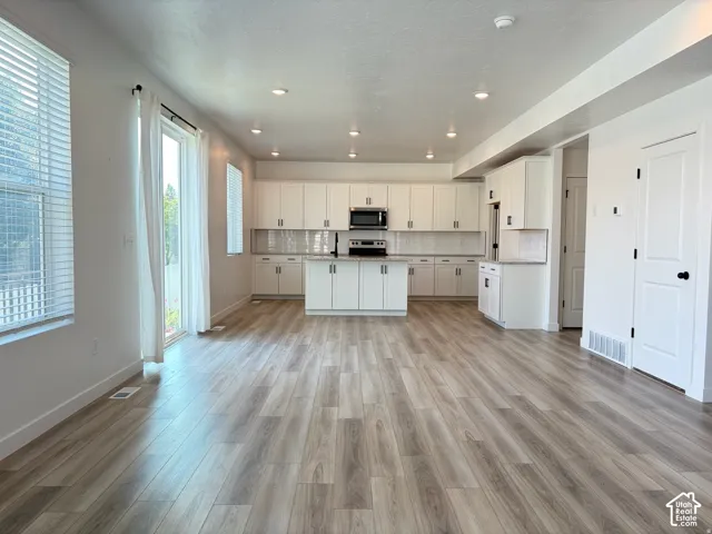 Open-concept living space with wood-finish flooring