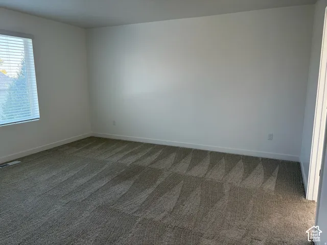 Owner's suite with Neutral wall paint, plush carpet flooring, window with horizontal blinds