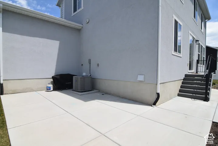 Outdoor concrete patio with exterior access to the property