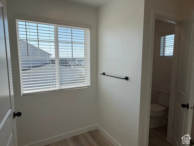 Owner's bathroom with private toilet room, Window with horizontal blinds and white trim