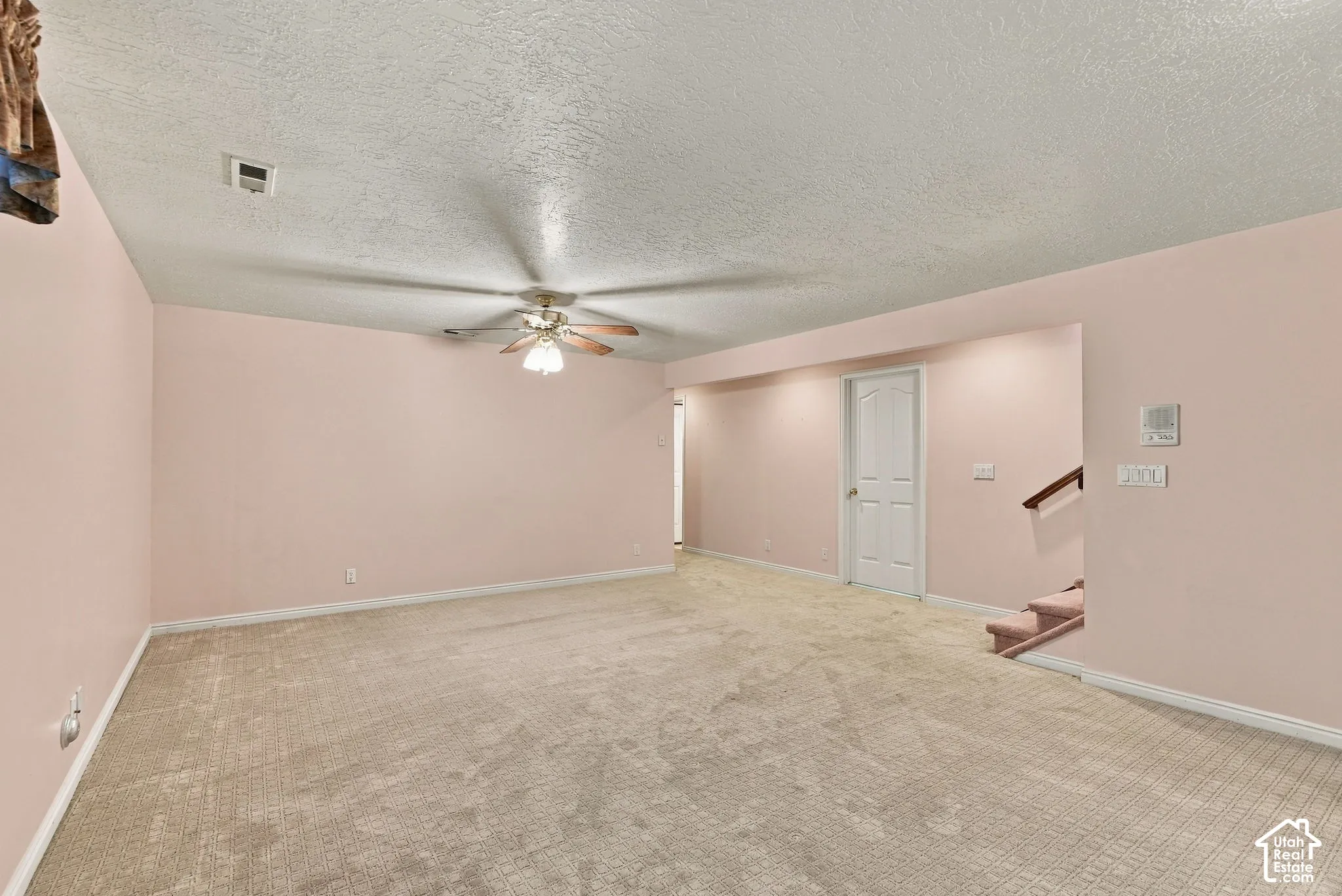 Spacious room with plush carpet flooring, recessed lighting, and a ceiling fan