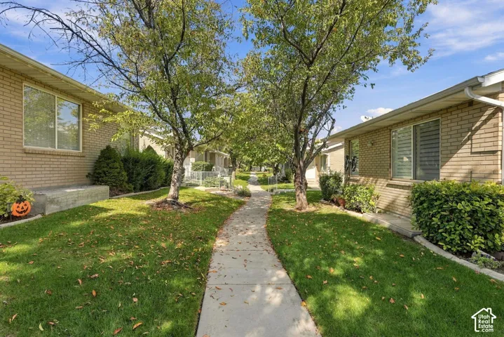 Landscaped walkway with mature trees and established plantings