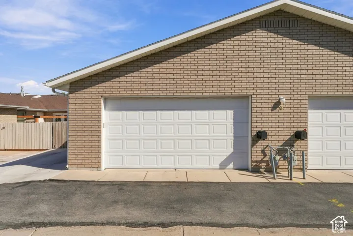 Brick exterior with two white paneled garage doors