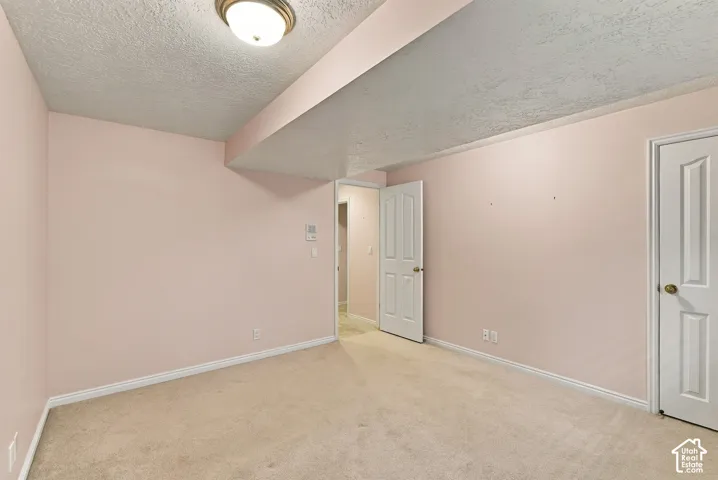 Carpeted flooring, recessed ceiling light fixture, and white trim