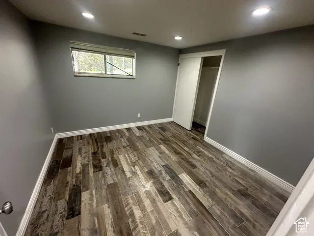 Wood-finish flooring, recessed lighting, and a window with natural light
