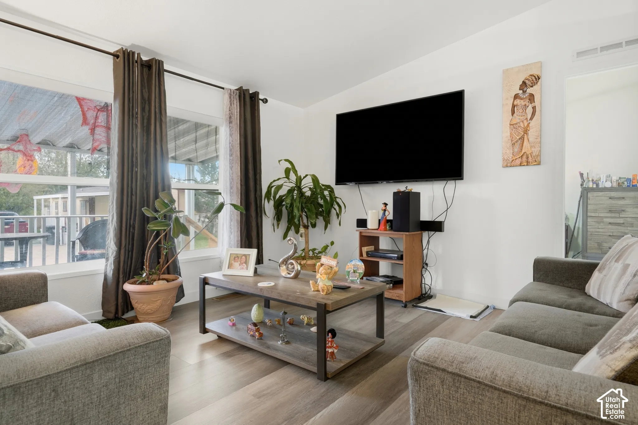 Recessed lighting, wood-finish flooring, and white walls create a bright interior