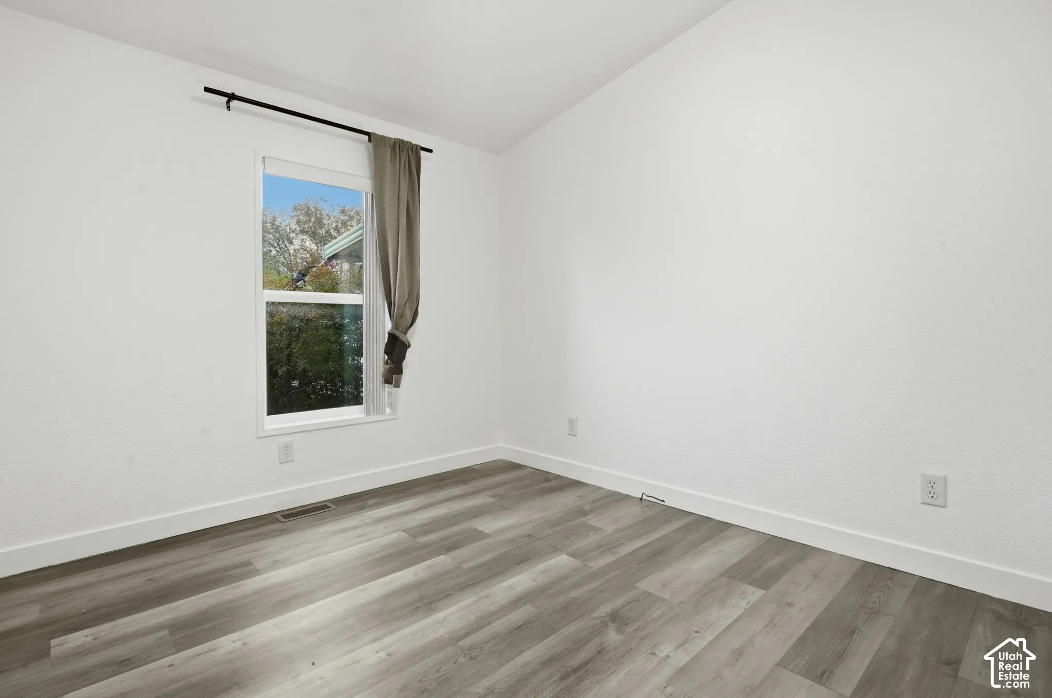 Neutral white walls with wood-finish flooring