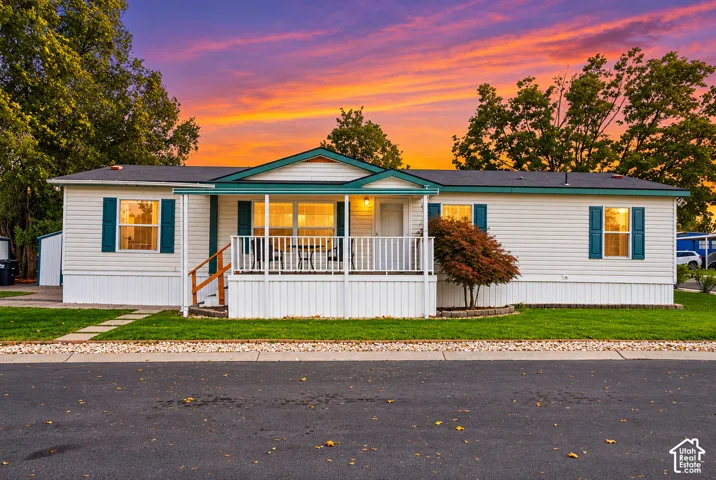 White siding exterior with teal shutters and trim