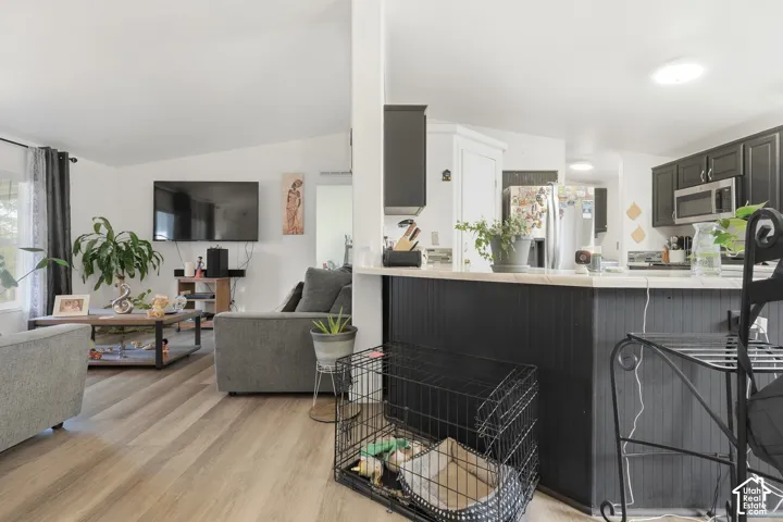 Open-concept living space with wood-finish flooring