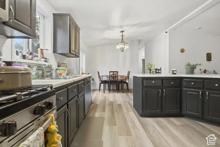 Kitchen featuring dark wood-finish cabinetry, light-toned countertops, and wood-finish flooring