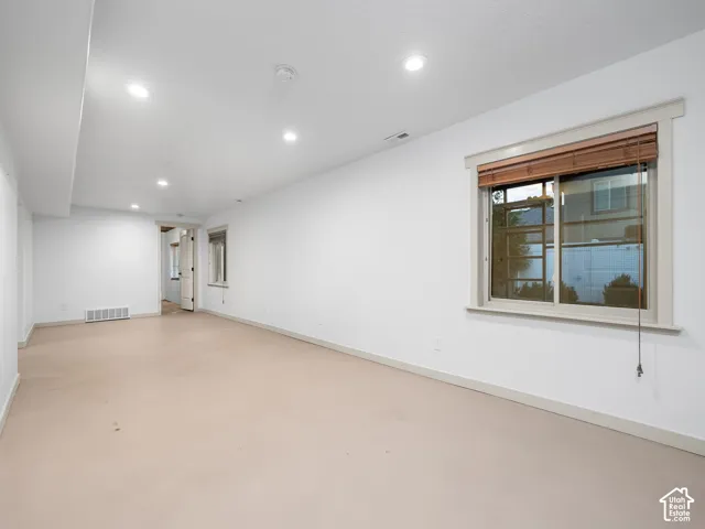 Recessed ceiling lighting, light-toned wall-to-wall carpeting, window with wood blinds, white painted walls, and white trim