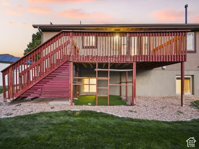 Elevated wood deck with a full staircase, offering exterior access to the upper level
