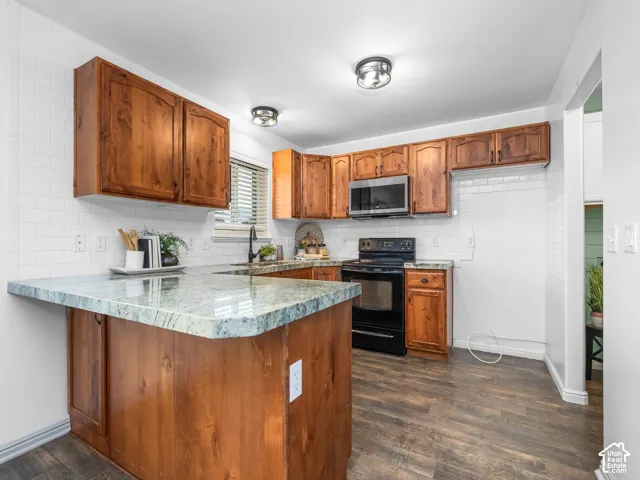 Wood-finish flooring, white subway tile backsplash, and light-toned countertops