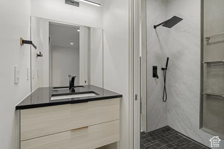Modern vanity with a dark countertop and integrated sink