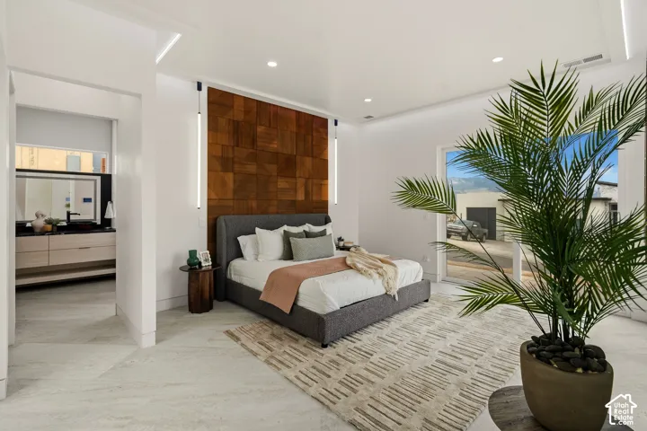 Recessed lighting, wood-paneled accent wall, and a large sliding glass door