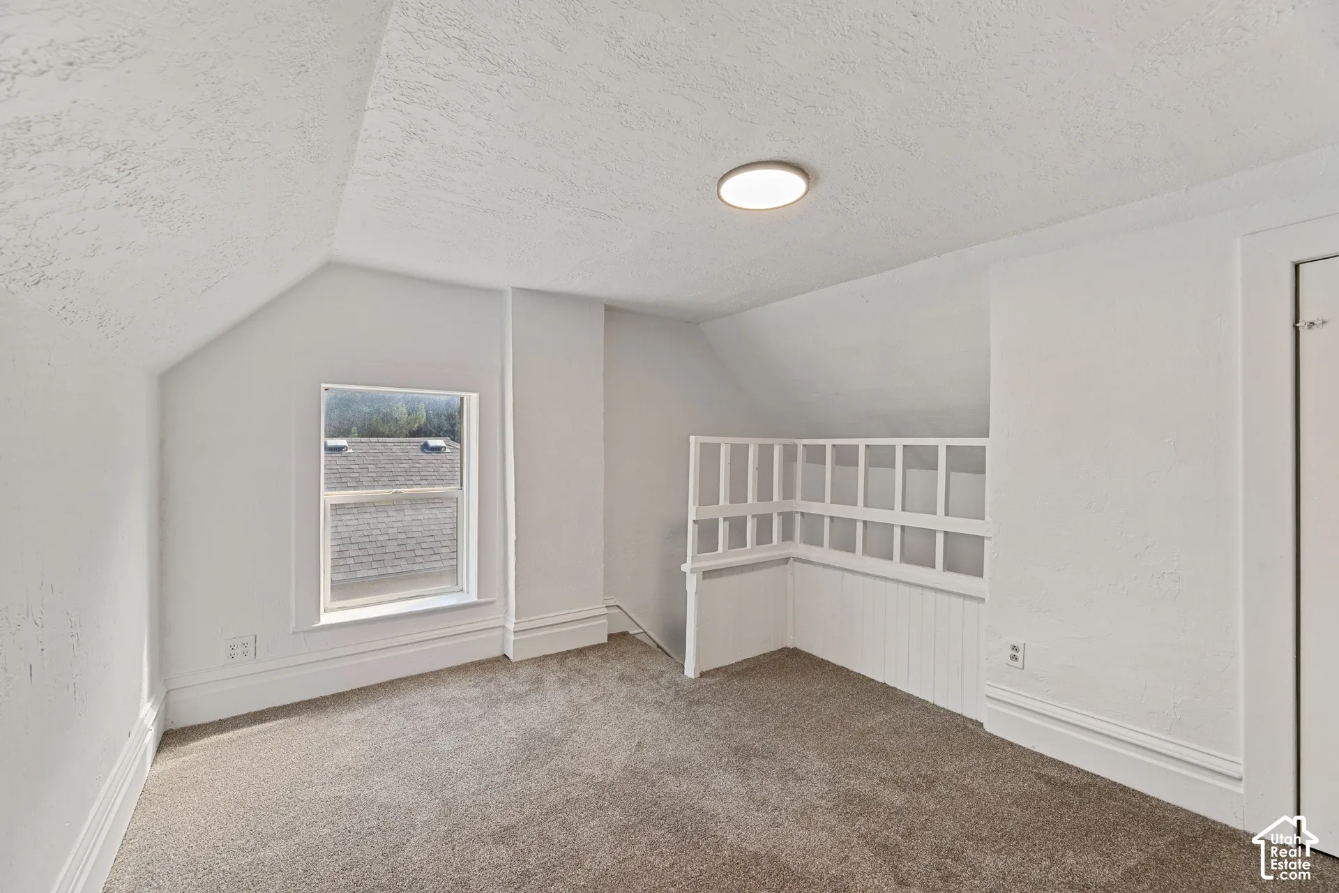 Main House Upstairs Loft Area with New Carpeted room with sloped ceilings, a single window, recessed lighting, and a built-in white railing feature