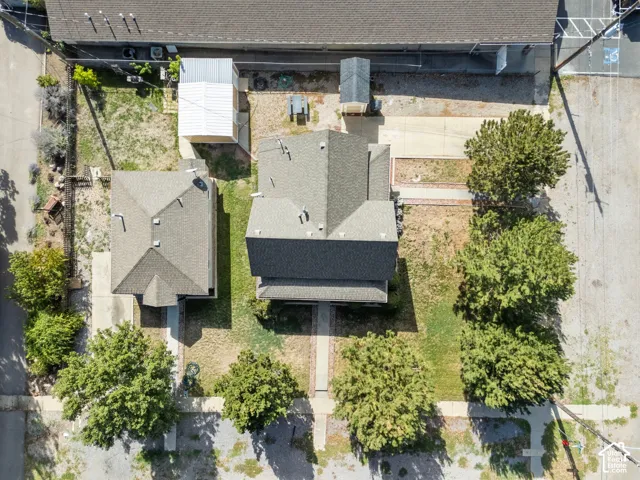 Two distinct structures with pitched roofs, front entryways, and surrounding green spaces