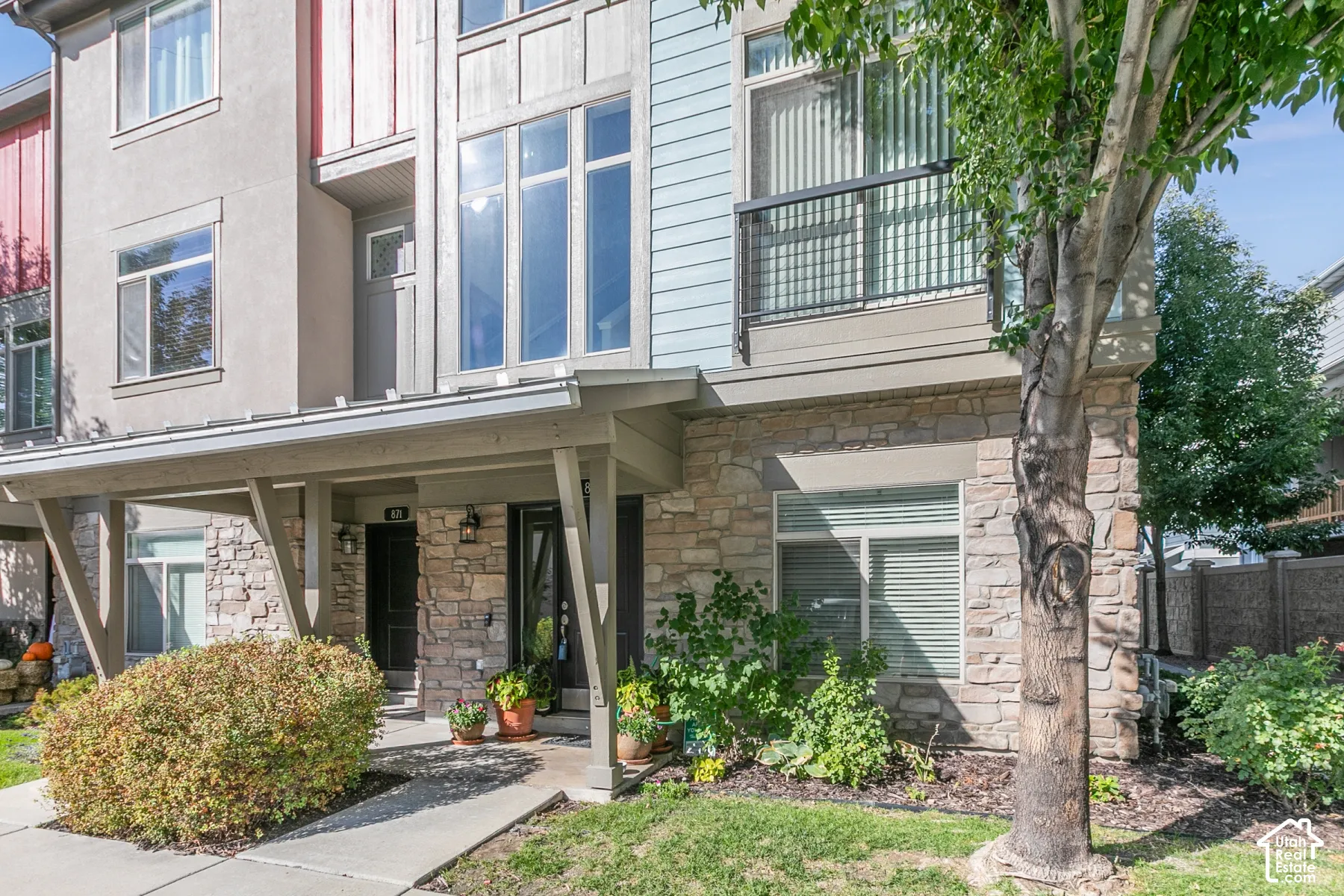 Stone veneer and siding exterior with a covered porch entry