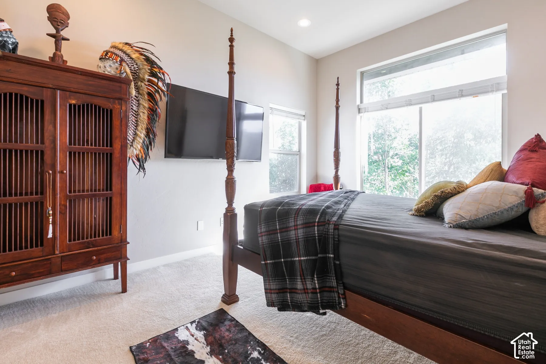 Recessed lighting, large windows, and light-toned wall paint