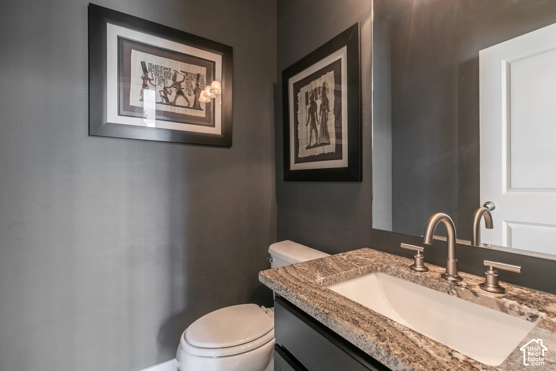 Vanity with a granite countertop and an undermount sink