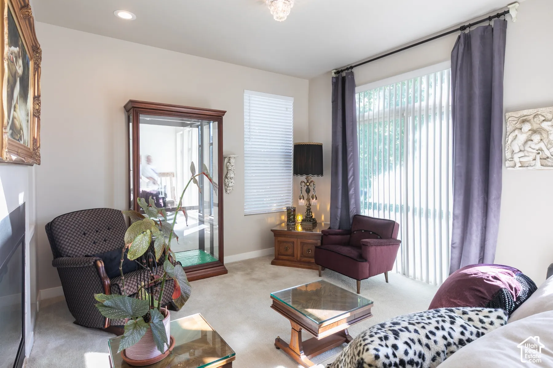 Recessed ceiling lighting, vertical blinds, light-colored carpeting, and a glass-paneled sliding door