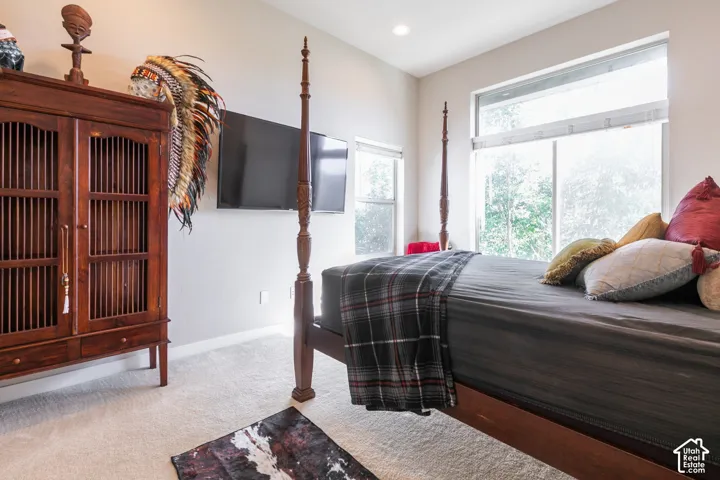 Recessed lighting, large windows, and light-toned wall paint