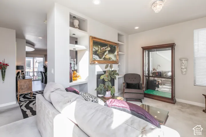 Integrated shelving, recessed lighting, and a built-in fireplace
