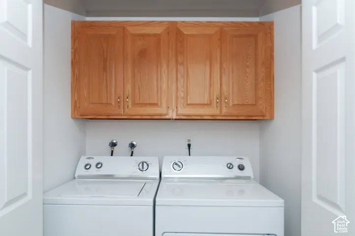 Built-in laundry closet featuring wood cabinetry